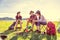 Group of campers discussing about picnic at meadow field with mountain and lake background. People and lifestyles concept. Hiking