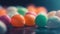 a group of candies sitting on top of a table next to a blue wall and a black background with a blue light in the middle