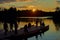 Group of canoers, preparing to go canoeing, sunset