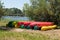 Group of canoes rental kayak on the lake shore beach