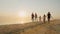 Group of carefree children of different ages and adults have fun running on the beach