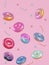 Group of cartoon donuts on pink background