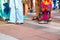 Group of casual men and women standing on paving