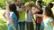 Group of casual young friends putting their hands together