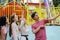 Group of Caucasian friends enjoy selfie on mobile phone at theme park