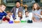 Group of caucasian school children in chemical lab. Pupils put dry ice into the flasks with colorful liquids which