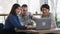 Group of charismatic and smiling large friends two ladies one guy meeting at the coffee shop they using laptop to watch