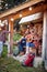 A group of cheerful friends having fun at cottage porch in the forest. Vacation, nature, cottage, friendship