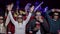 A group of cheerful friends watch 3D movie in glasses in the cinema.