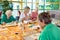 Group of cheerful older students painting together