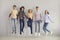 Group of cheerful school, college or university friends jumping for joy together