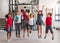 A group of cheerful small school kids in corridor, jumping.