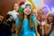 Group of cheerful young girls celebrating Christmas. Headphones