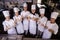 Group of chefs showing thumbs up sign in kitchen