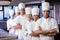 Group of chefs standing in kitchen