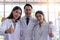 Group of chemical showing thumbs up while standing together in the laboratory. Team science people wear white coat
