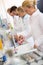 Group of chemical technicians work with test tubes in lab