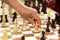 Group of chess pieces on the portable board.Man moving figure,closeup photography.Playing in the park concept.Family rest or