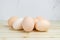 Group of chicken eggs on wooden tabletop. Fresh farm organic products, preparing for Easter