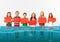 Group of children with blank red banners standing in water of melting glacier, global warming