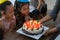 Group of children blowing birthday cake in birthday party singing happy birthday