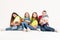 A group of children in bright clothes with their favorite soft toys in their hands on a white background. Studio photo. Baby