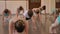 A group of children do a warm-up before a dance lesson in the ballet Studio.