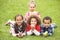 Group Of Children Laying On Grass With Easter Eggs