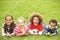 Group Of Children Laying On Grass With Easter Eggs