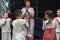 A group of children in national dress perform an Estonian folk dance