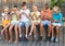Group of children playing with mobile phones outdoors