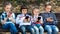 Group of children posing with mobile devices