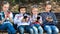 Group of children posing with mobile devices