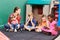 Group of children reading book in preschool