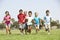 Group Of Children Running In Park