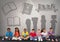 Group of children sitting in front of book reading silhouette graphics