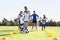 Group Of Children In Soccer Team Having Training With Coach