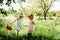 Group Of Children Wearing Bunny Ears Running To Pick Up colorful Egg On Easter Egg Hunt In Garden