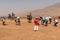 Group of Chinese tourists taking pictures near the Flaming Mountains, Xinjiang