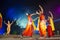 A group of Classical Odissi dancers performing Odissi Dance on stage at Konark Temple, Odisha, India.