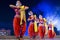 A group of Classical Odissi dancers performing Odissi Dance on stage at Konark Temple, Odisha, India.