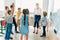 group of classmates standing around teacher at classroom