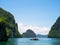 Group of cliff tropical islands and traditional longtail boat in Thailand