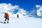 Group of climbers with backpacks reaches the summit of mountain