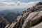 group of climbers on large granite wall, with view of the surrounding landscape