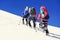 Group of climbers reaches the top of mountain peak. Climbing and