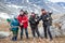 Group of climbers showing thumbs up, portrait of senior couple, teenage boy and adult man, people dressing mountaineering outfit