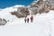 Group of climbers walking on a glacier.