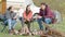 Group of close friends sitting on camping chairs