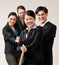 Group of co-workers pulling rope in tug-of-war